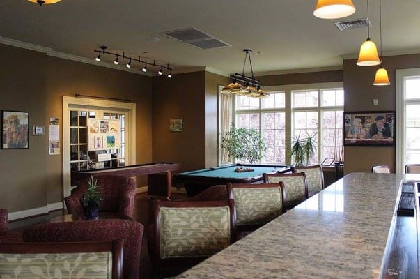 Bright common area with billiard table and seating