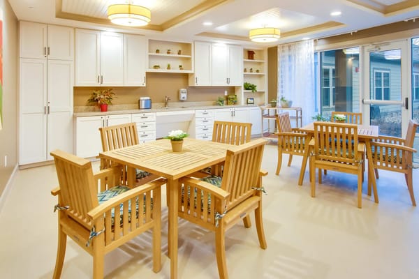 Bright common area with wooden furniture and plants