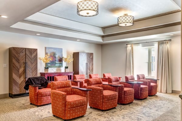 Bright and inviting common area with orange chairs