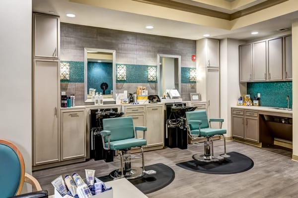 Hair salon area with styling chairs and mirrors