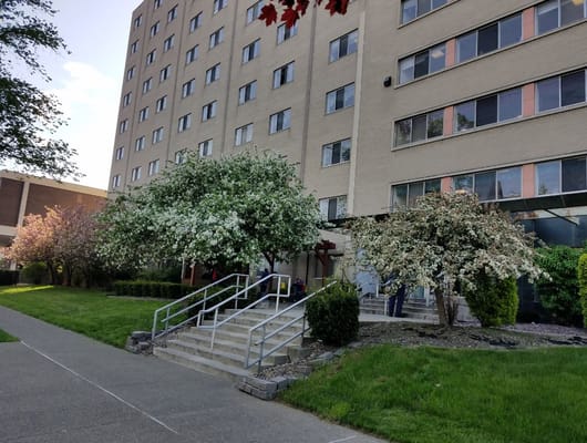 Exterior view of Mary Agnes Manor with flowering trees
