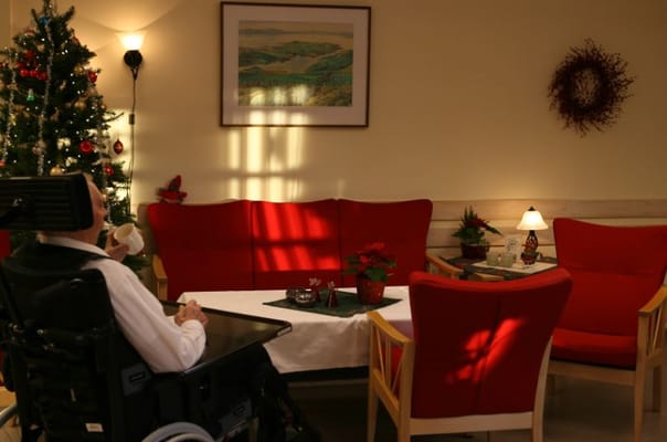 Residents enjoying a cozy common area with festive decor