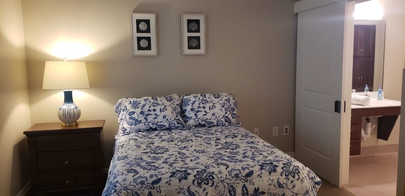Cozy resident room with floral bedding and lamp