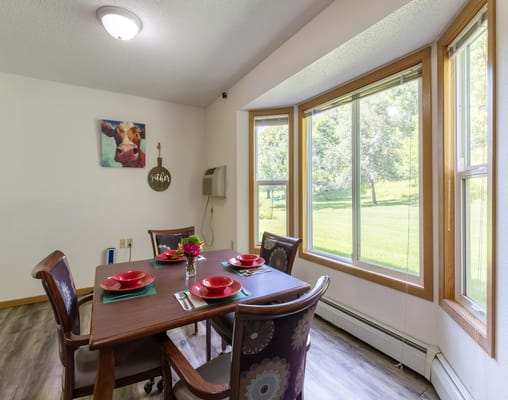 Bright dining room with a table set for a meal
