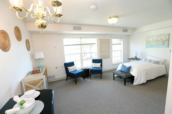 Cozy resident room with bed and seating area