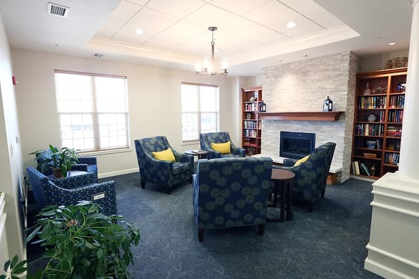 Cozy common area with chairs and a fireplace