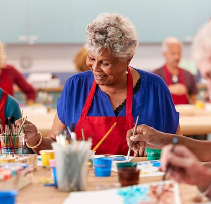 Residents participating in a painting activity in a common area