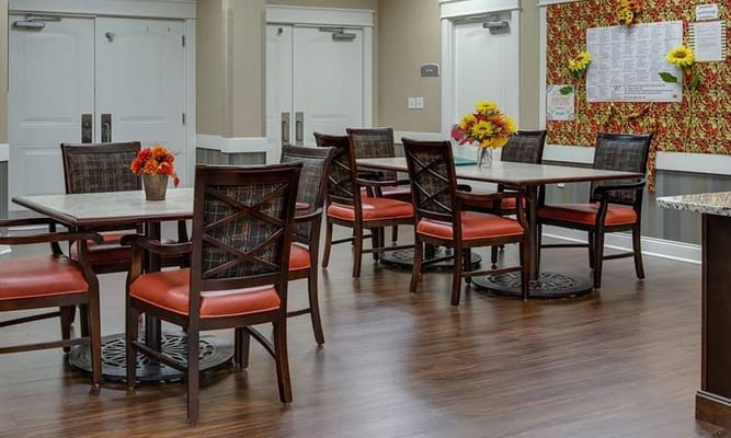 Dining area setup with tables and flowers