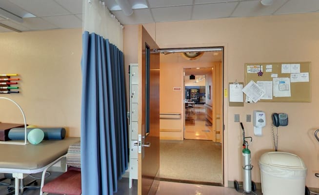 Therapy room entrance with equipment and amenities visible