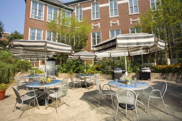 Outdoor dining area with tables and umbrellas