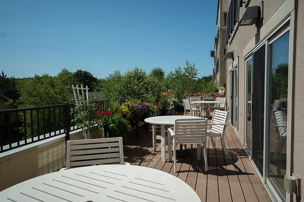 Outdoor patio with seating and colorful flowers