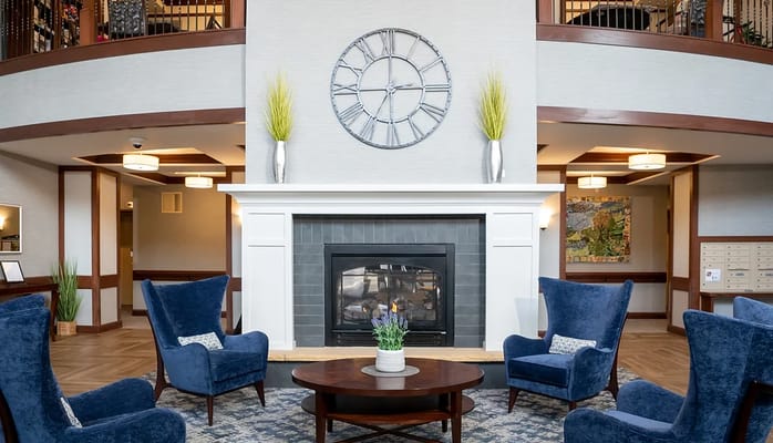 Interior common area with a fireplace and seating