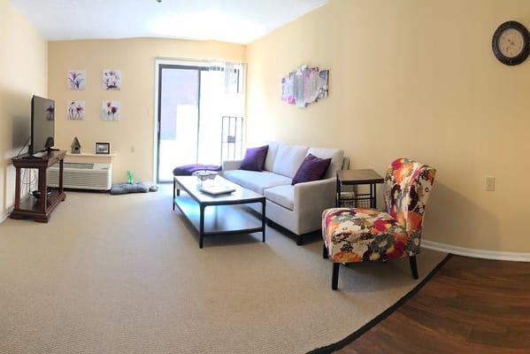 Cozy living room with floral armchair and TV