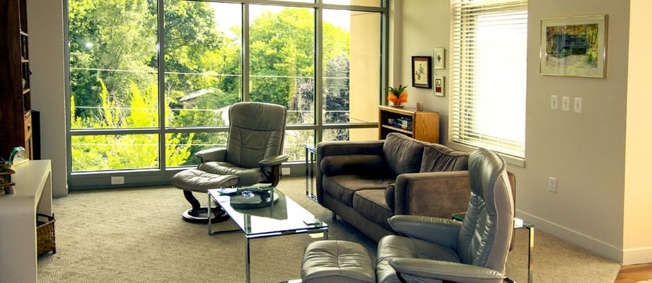 Bright common area with large windows and comfortable seating