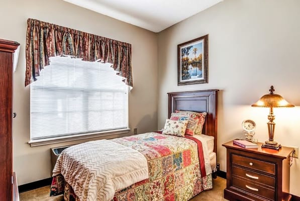 Cozy bedroom with a floral bedspread and a window