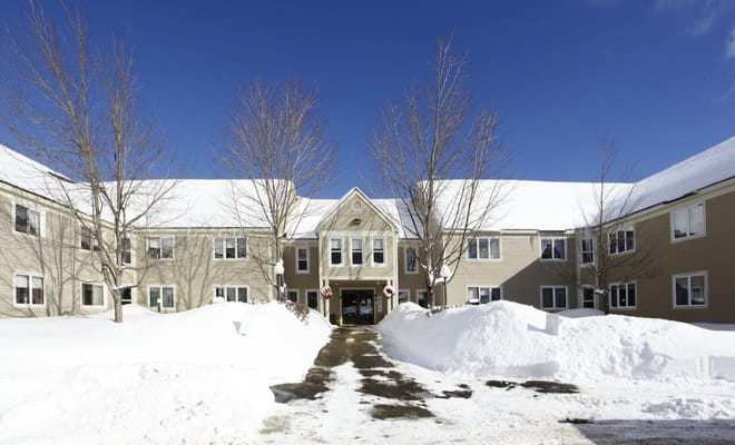 Snow-covered entrance of Oxford Meadow Apartments