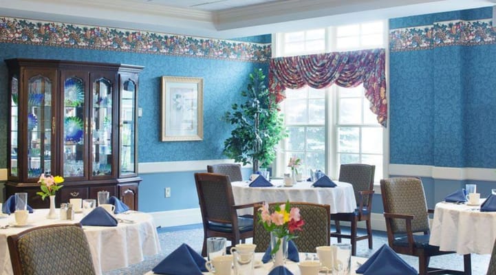 Bright dining room with tables set for a meal