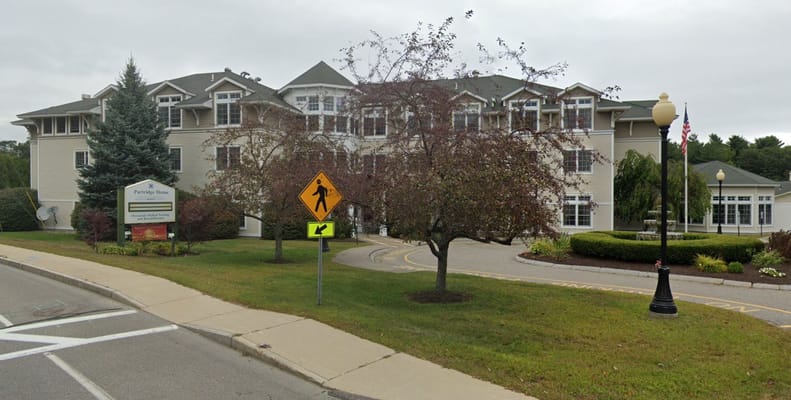 Front view of Partridge House with signage and landscaping.