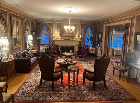Elegant living room with red chairs and a fireplace