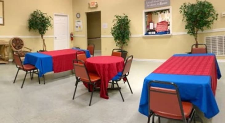 Bright dining area with colorful tablecloths and chairs