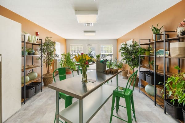 Bright common area with plants and seating.