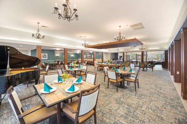 Spacious dining room with tables set for a meal.