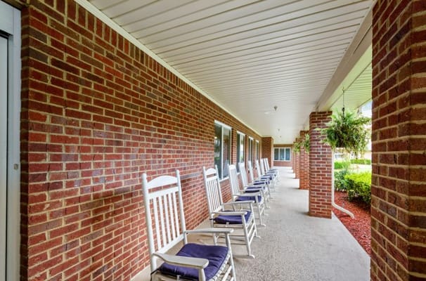 Outdoor rocking chair area beside the building