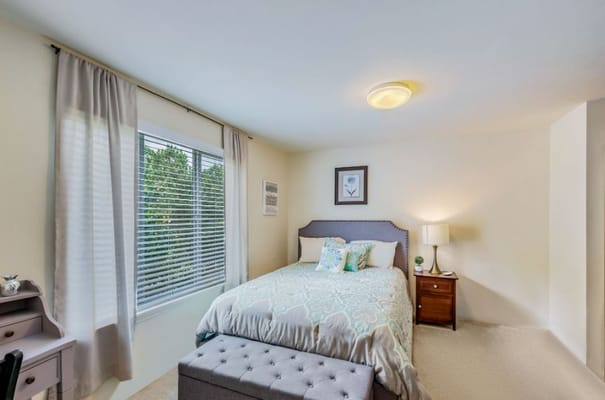 Cozy private resident room with a bed and desk