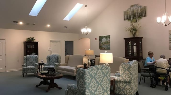 Common area with seating and residents socializing