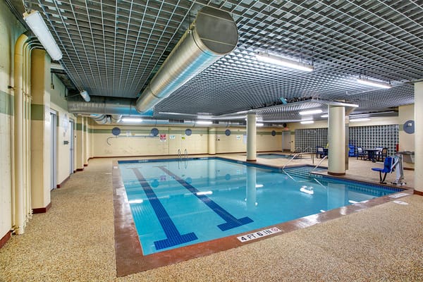 Indoor swimming pool area with seating