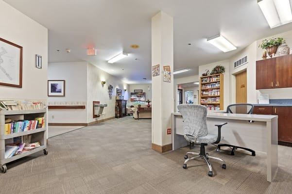 Bright and open common area with seating and bookshelves