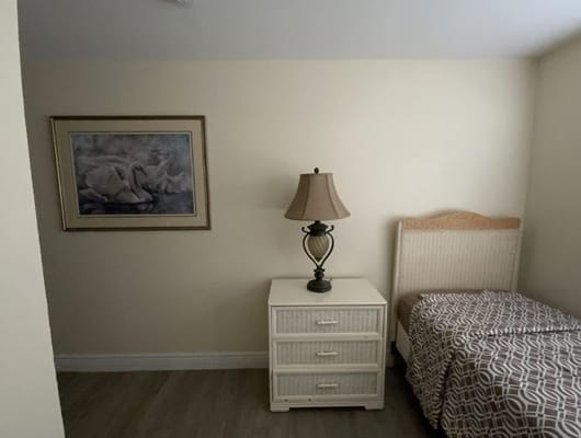 Cozy bedroom with a lamp and artwork