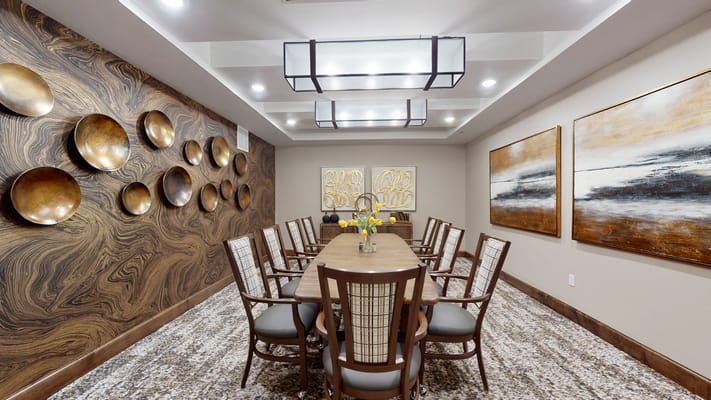 Interior meeting room with a long table and decorative wall art
