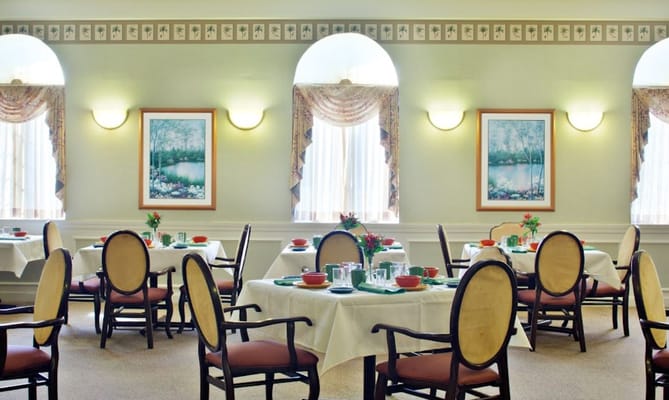 Dining room with tables set for meals at RegalCare at Lowell