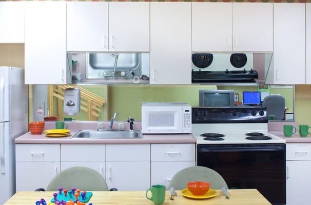 Modern kitchen setup with appliances and dining ware.