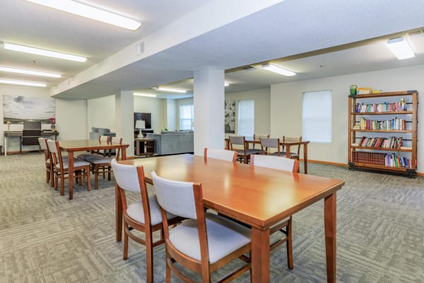 Bright common area with tables and bookshelves