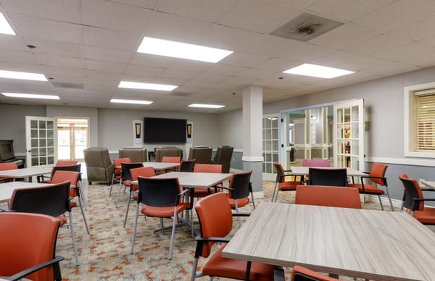 Brightly lit common area with seating and tables