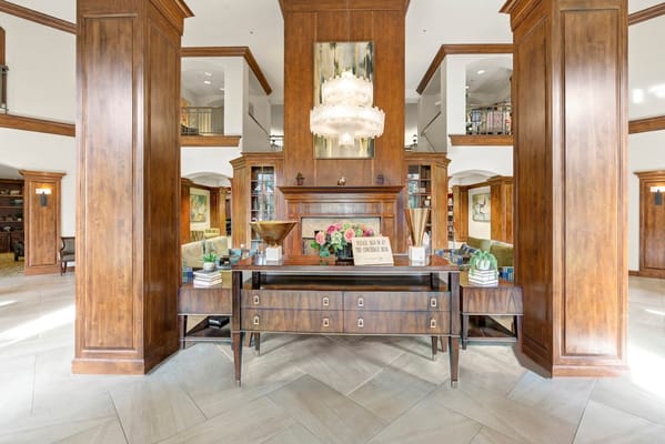 Elegant lobby with wooden columns and a chandelier