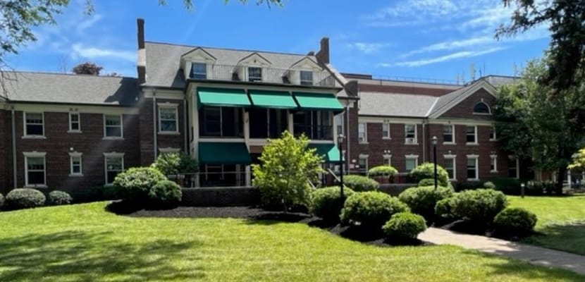 Exterior of Rochester Presbyterian Home featuring green awnings and landscaped grounds.