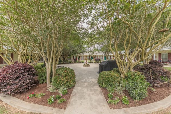 Pathway through landscaped courtyard at Rosewood Assisted Living