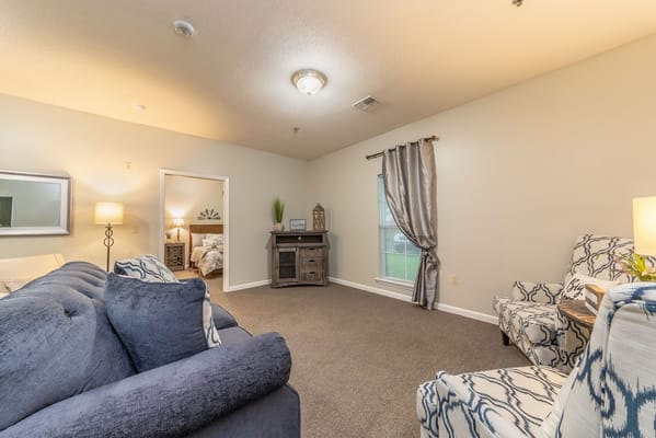 A spacious living room with comfortable seating and natural light.