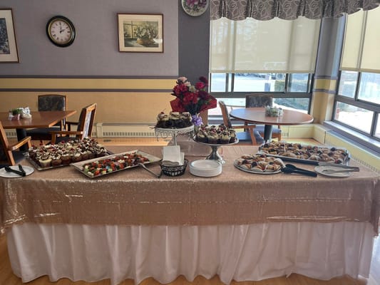 Table with assorted desserts in a communal dining area