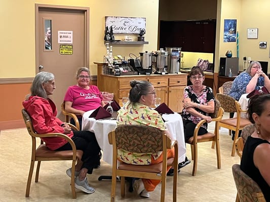 Residents enjoying company in the dining room area