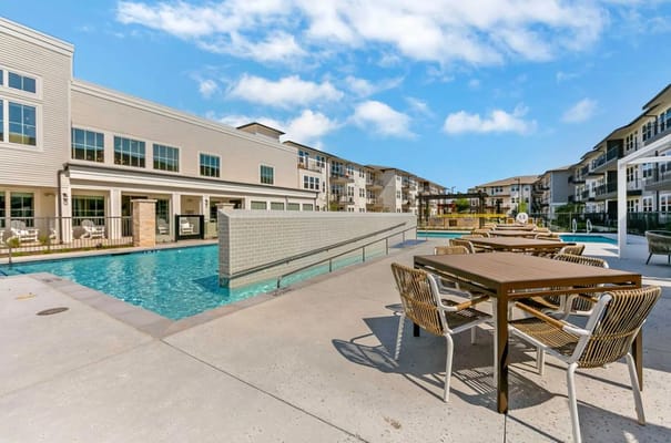 Outdoor pool area with seating at Sage Cobblestone