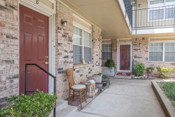 Entrance area with seating and plants outside a senior housing unit