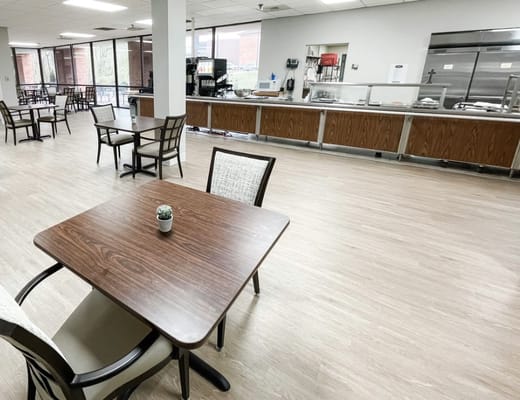 Dining area with tables and a serving counter
