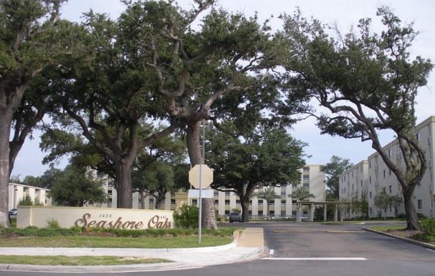 Entrance sign of Seashore Oaks Assisted Living surrounded by trees