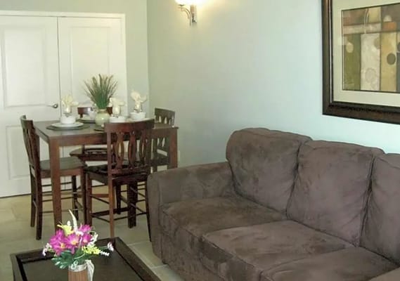 Cozy living room area with sofa, dining table, and decor