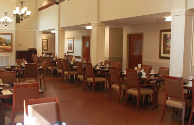 Dining room with tables and chairs set for a meal