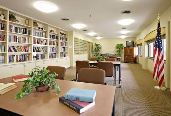 Interior view of a common area with bookshelves and seating